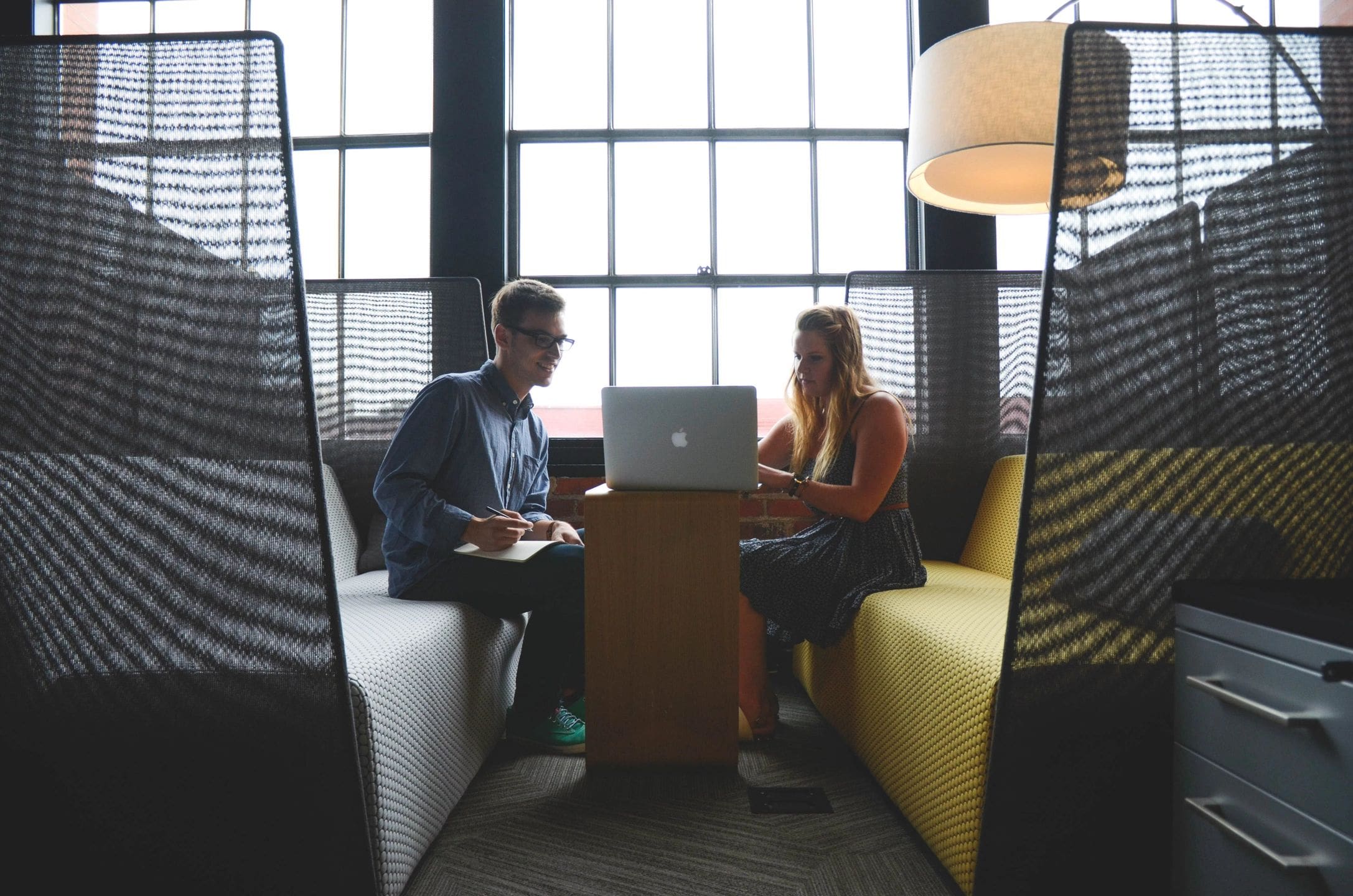 man and woman having a meeting in a nice office